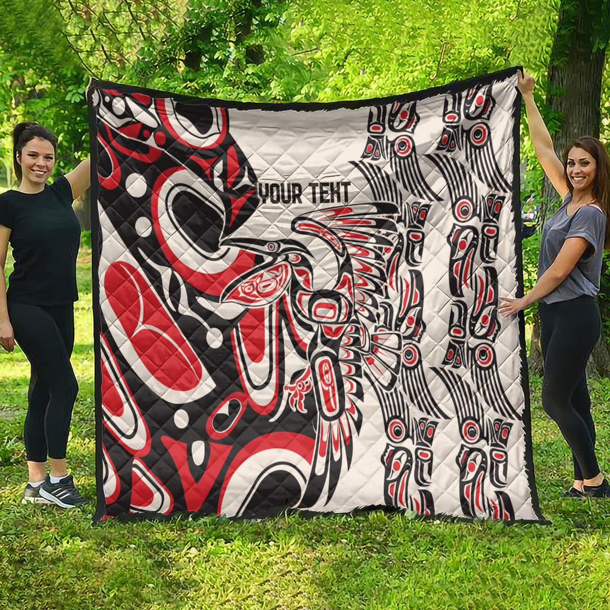 Personalized quilt in red, black, and white with “YOUR TEXT” and intricate tribal figures
