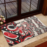 Personalized rubber doormat with bold red and black tribal motif, 'YOUR TEXT' visible