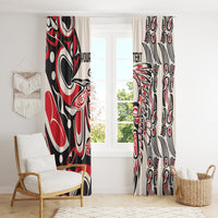 Red, black, and white tribal pattern window curtains hanging across a large window