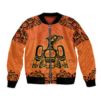 Orange bomber jacket with full-zip front, black ribbed collar, and bold indigenous art panel