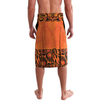 Orange board shorts with black tribal-style pattern, mid-thigh length, elastic waistband.