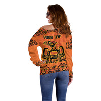 Orange off-shoulder sweater back view with "YOUR TEXT" graphic panel.