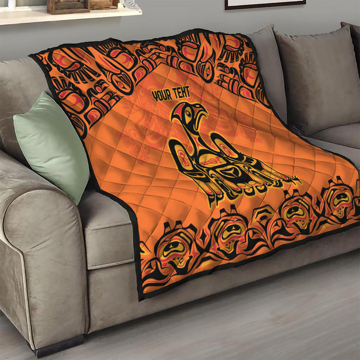 Orange quilt blanket with black border, Haida-style raven figure and "YOUR TENT" text