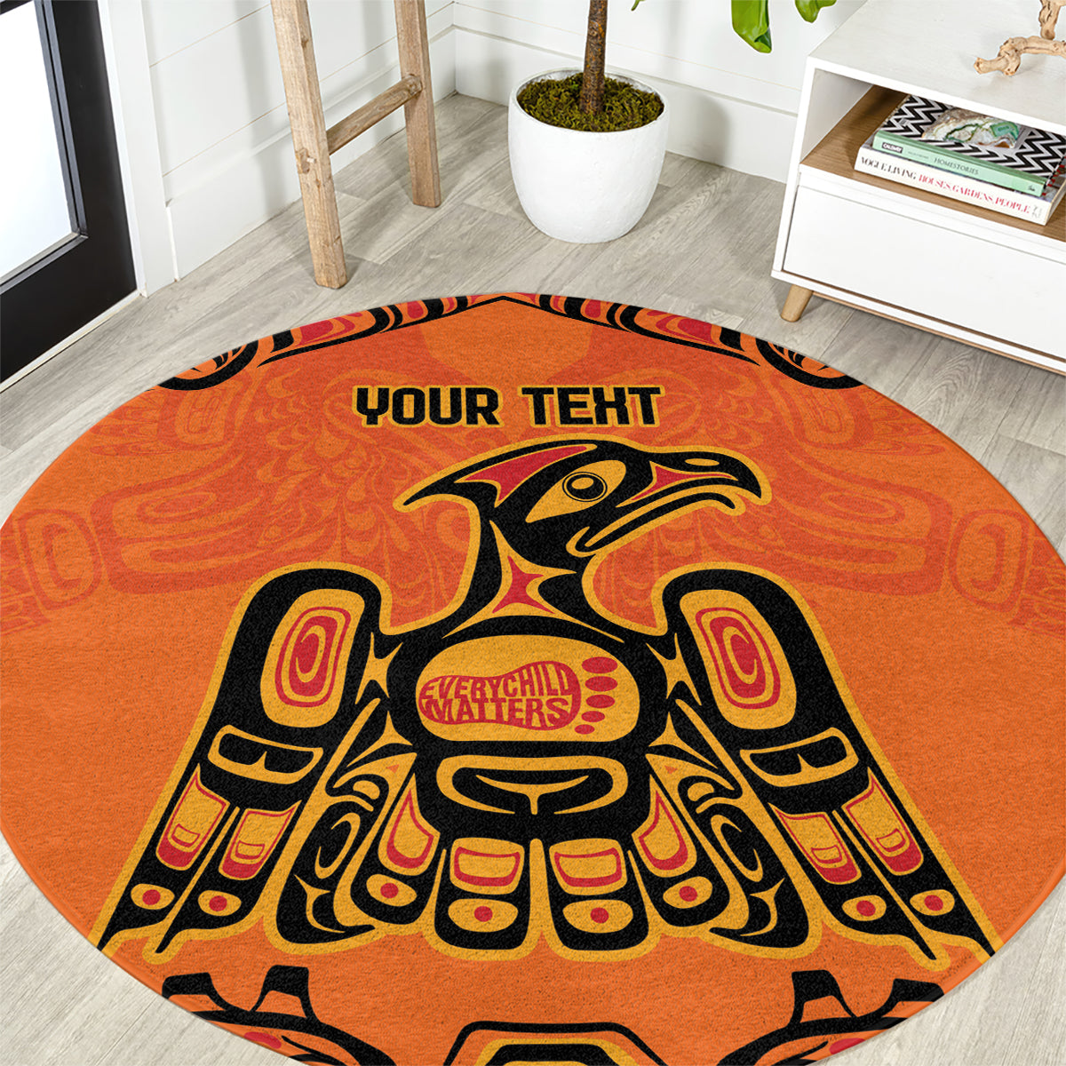 Round orange patterned area rug with eagle figure design and 'YOUR TEXT' in center