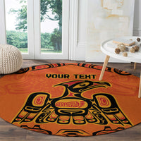 Round orange area rug featuring eagle figure art and 'YOUR TEXT' text near top
