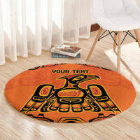 Round orange patterned rug with eagle motif and 'YOUR TEXT' text across middle