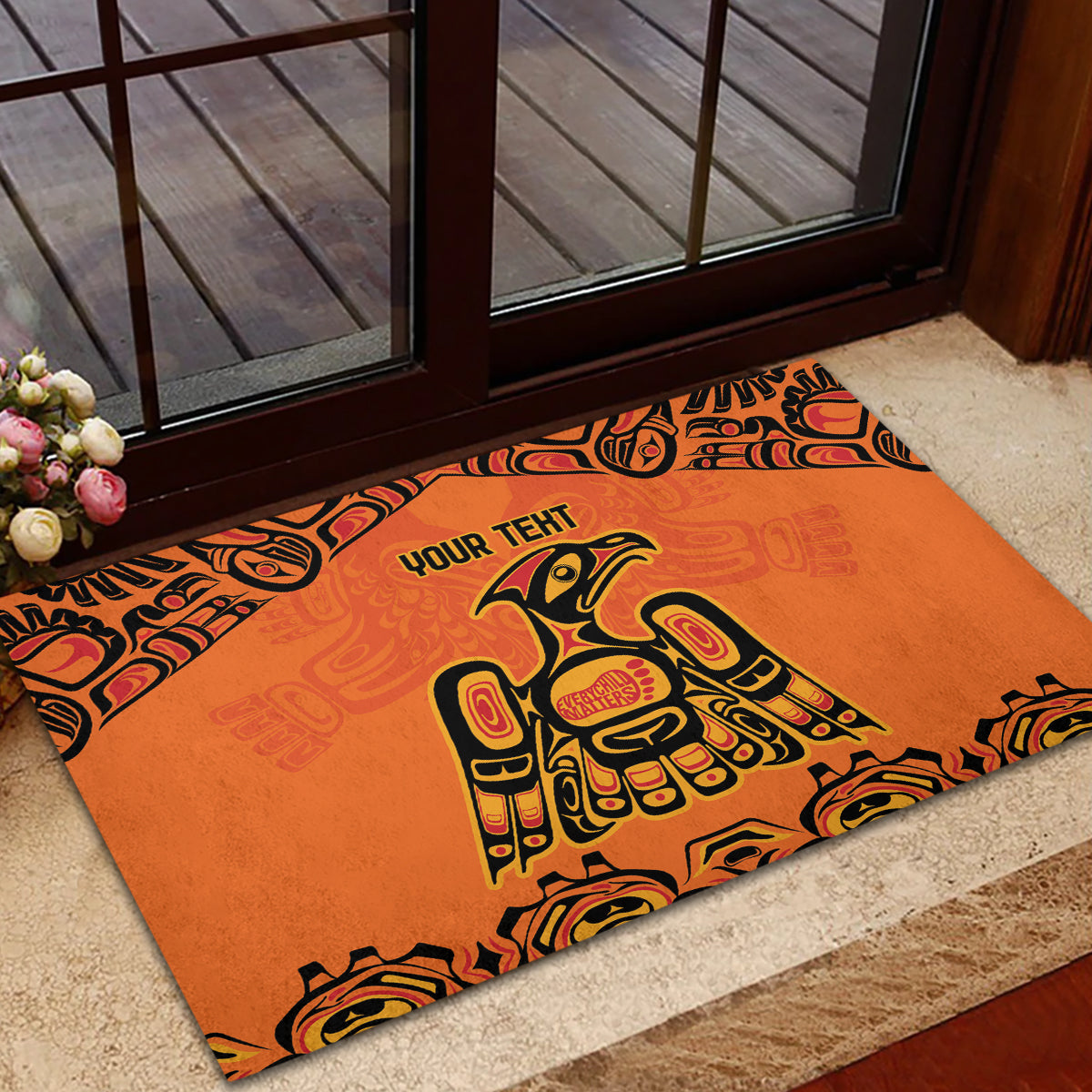 Orange rubber doormat with 'YOUR TEHT' and large totem figure design in black
