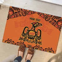 Orange rubber doormat with 'YOUR TEHT' and tribal patterned border in black