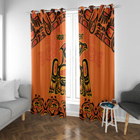 Orange curtains with black and yellow Indigenous totem pattern, eyelet-style header visible.