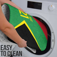 Green bath mat with yellow number 21 design being placed in washing machine