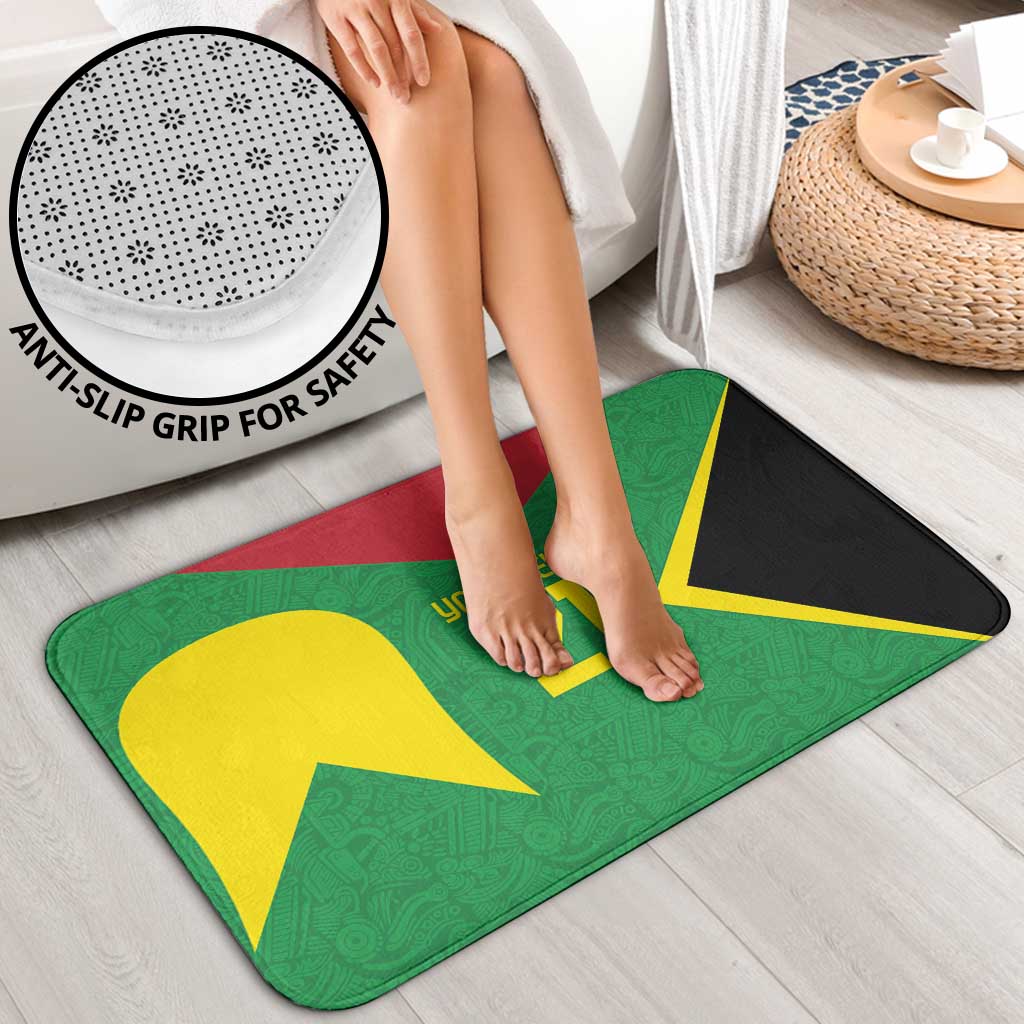 Green bath mat with yellow 21 design and non-slip grip, stepped on with bare feet