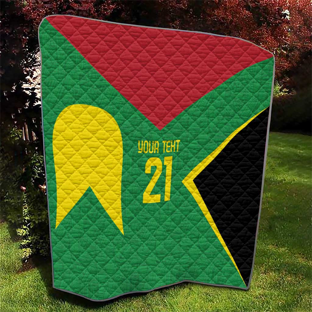 Folded green quilt featuring large yellow emblem, '21', red triangle, and black side