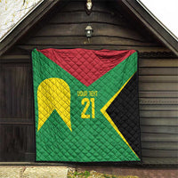 Green quilt with red top, yellow emblem, '21' text, and black quilted side