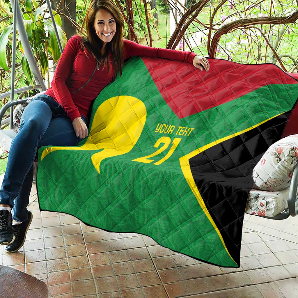 Green quilt draped on patio, yellow emblem, red triangle, '21' custom text