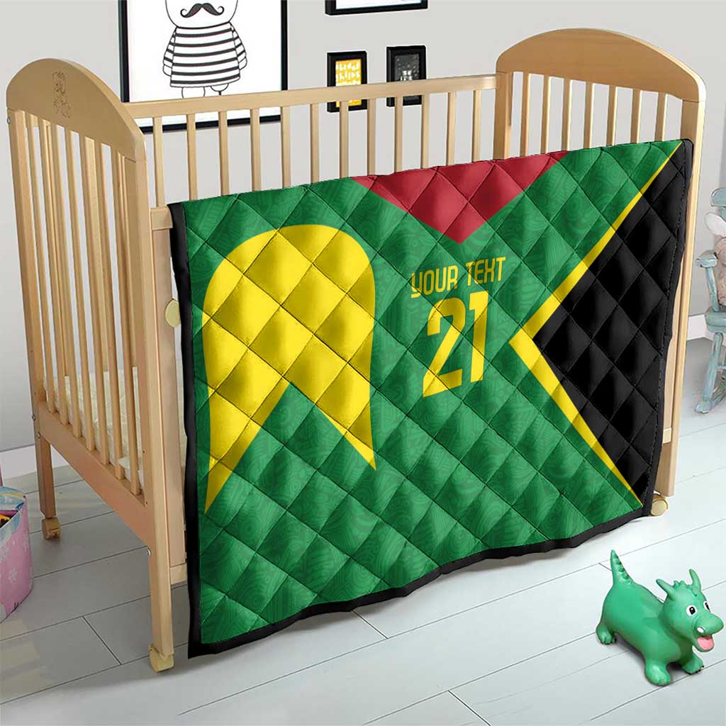 Green quilt on crib with yellow emblem, '21' custom text, red accent, black border