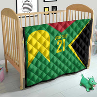 Green quilt on crib with yellow emblem, '21' custom text, red accent, black border
