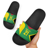 Custom black slide sandals shown in hand, green star graphic strap with red-yellow accents