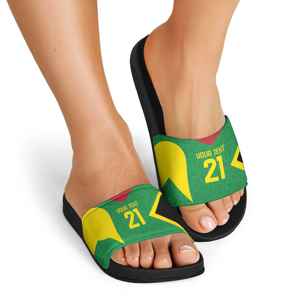 Custom green slide sandals with black sole on feet, star graphic strap with red-yellow accents