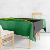 Green custom tablecloth with gold accents and black center panel, draped on table