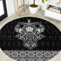 Black round area rug with white Viking-style knot and cross emblem border