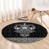 Black round Viking-style rug with central crest motif and patterned border