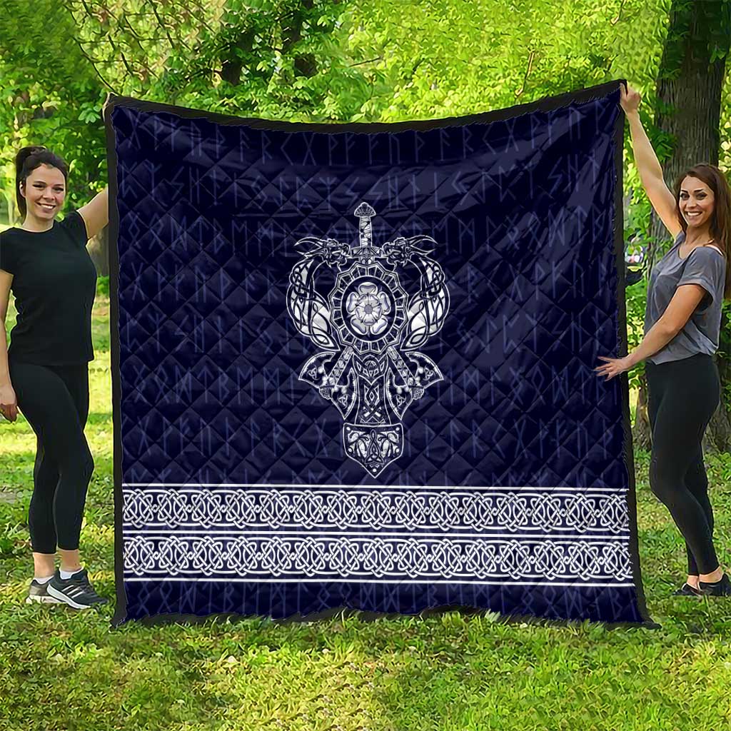 Blue blanket quilt with central white Viking axe symbol and decorative white border stripe