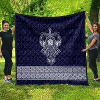 Blue blanket quilt with central white Viking axe symbol and decorative white border stripe