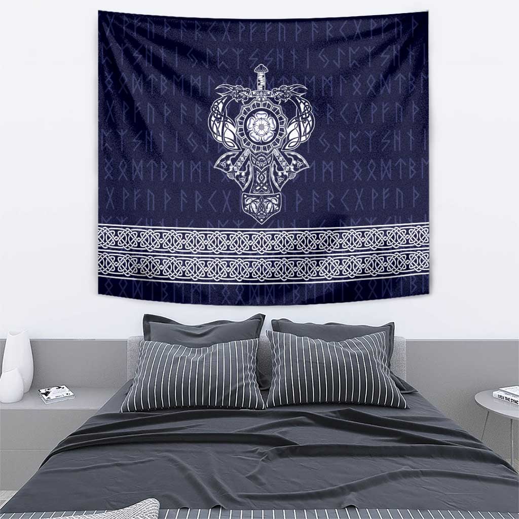 Wall-hung blue tapestry with central emblem and detailed ornamental band