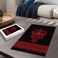 Red and black Viking rune jigsaw puzzle on tabletop with matching puzzle box nearby.