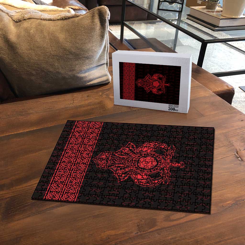 Red and black Viking rune jigsaw puzzle with 300-piece box on wooden table, central emblem.
