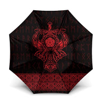 Red-and-black Viking-style umbrella with central rune knot design, closed