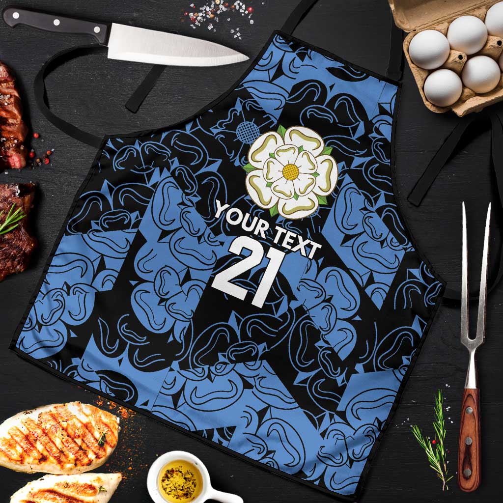 Custom apron laid flat with blue swirls; floral badge, 'YOUR TEXT' and 21 print