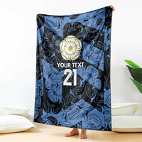 Personalized fleece blanket with blue and navy pattern, flower emblem, 'YOUR TEXT' and 21, standing