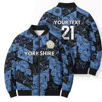 Blue patterned bomber puffer jacket showing front and back with zip and crest