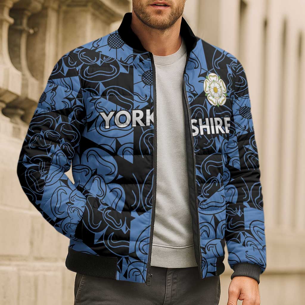 Blue patterned bomber puffer jacket on model, full zip, ribbed collar and cuffs