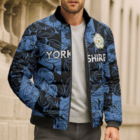 Blue patterned bomber puffer jacket on model, full zip, ribbed collar and cuffs