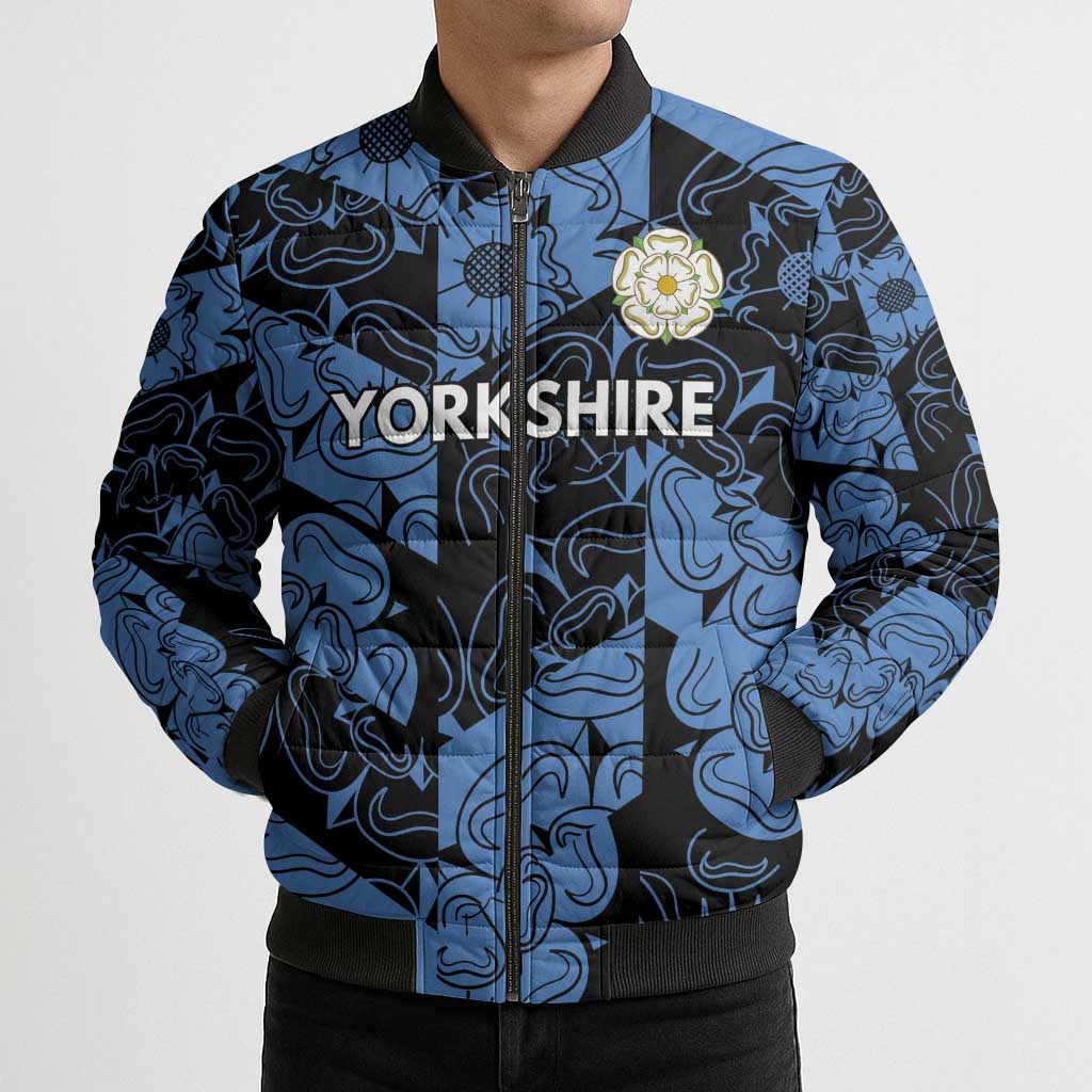 Blue and black patterned bomber puffer jacket front with Yorkshrie text and flower crest