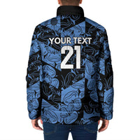 Blue patterned padded jacket with black hood and large back graphic, full-zip