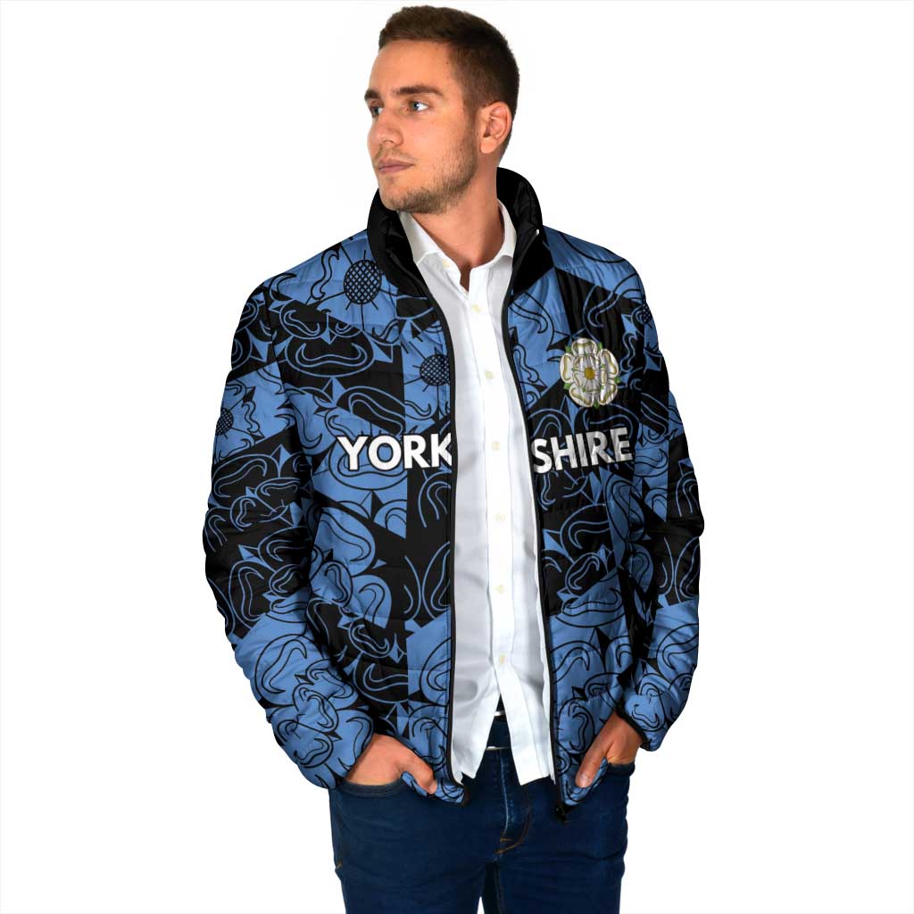 Blue patterned padded jacket with black hood, full-zip front, crest detail