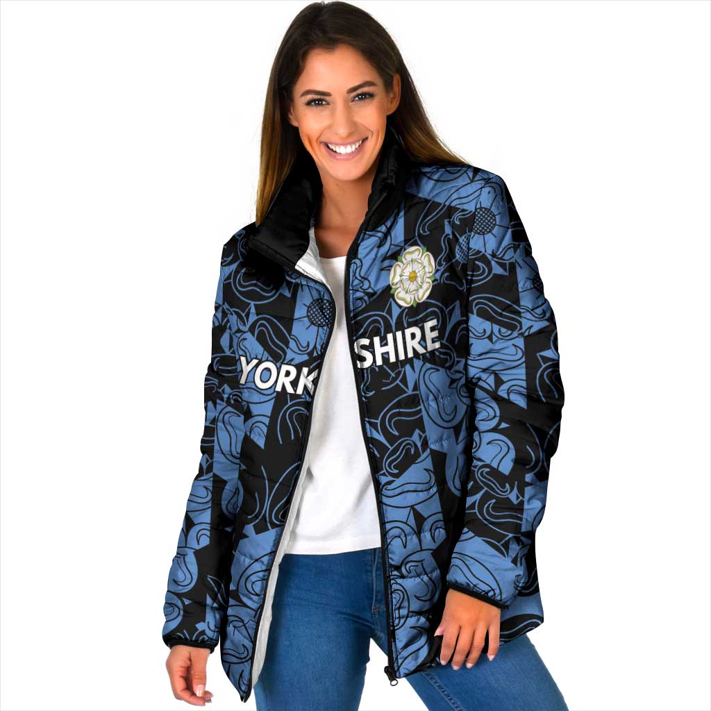 Blue patterned padded jacket with black hood, full-zip front, crest badge