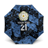 Blue patterned custom umbrella with rose emblem and “YOUR TEXT 21” on canopy