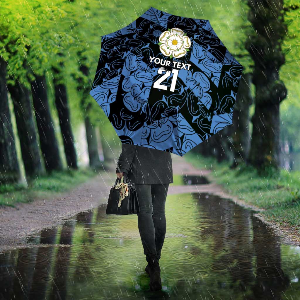 Blue patterned umbrella with rose emblem and “YOUR TEXT 21” held overhead