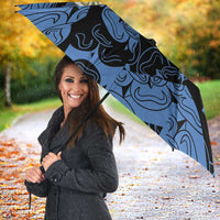 Blue patterned custom umbrella with rose emblem and “YOUR TEXT 21” open outdoors