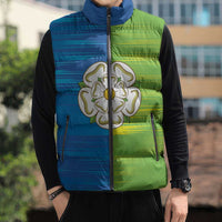 Sleeveless puffer vest on model, blue-to-green gradient, rose emblem, zip-front and pockets