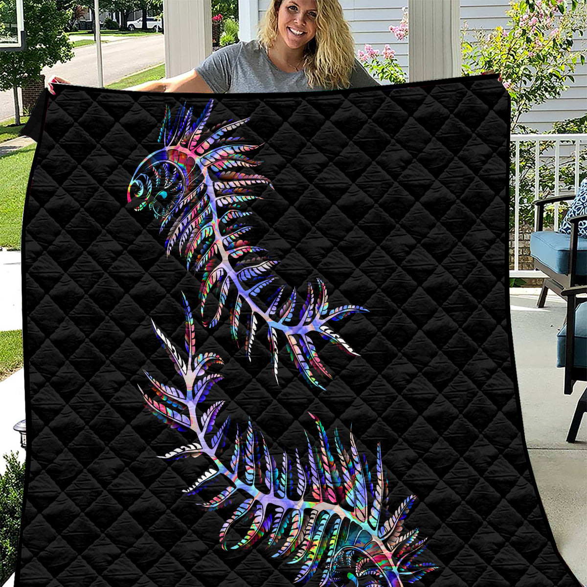 Black quilt with colorful fern feather design, quilted diamond pattern