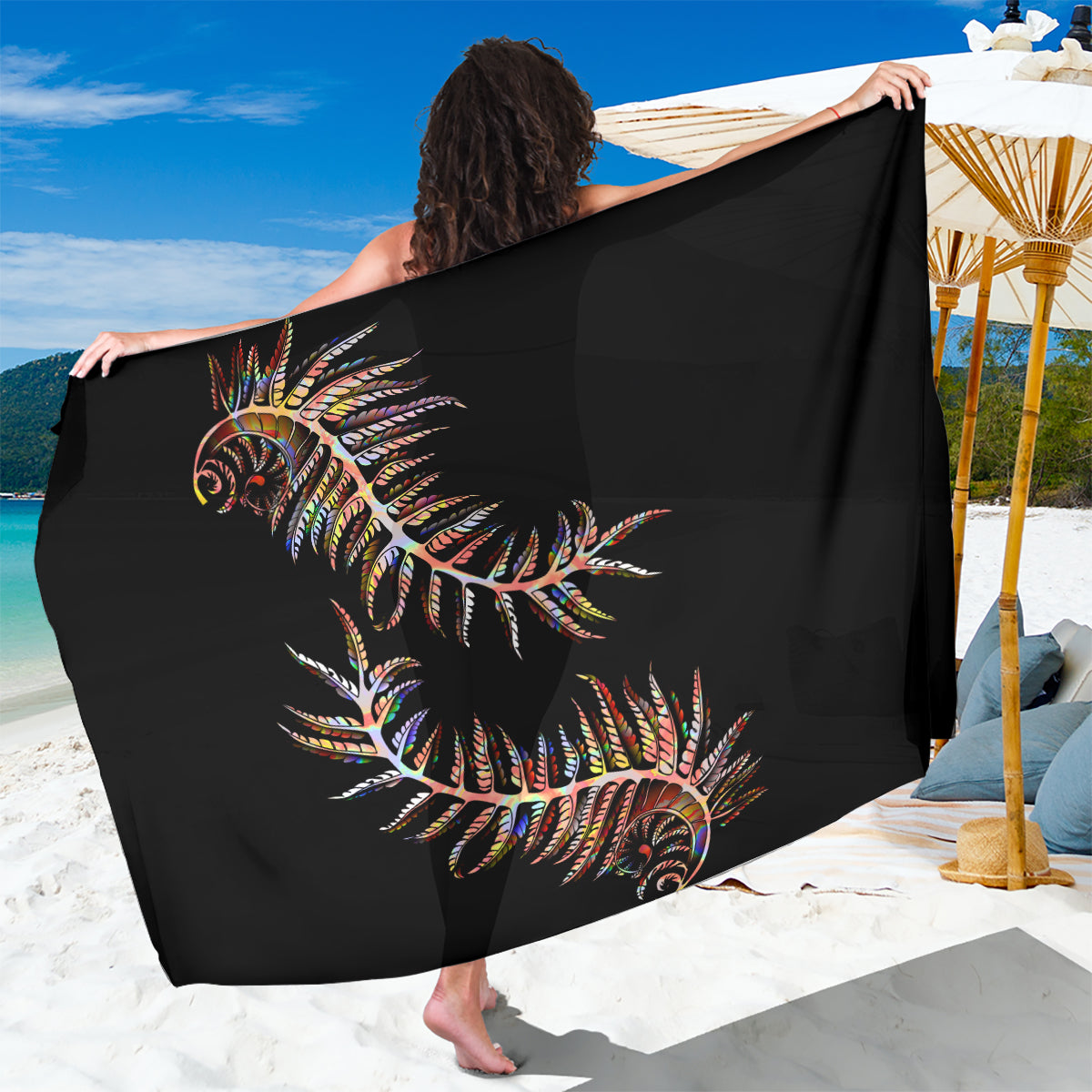 Black sarong with colorful tropical fern print, draped for beach wrap