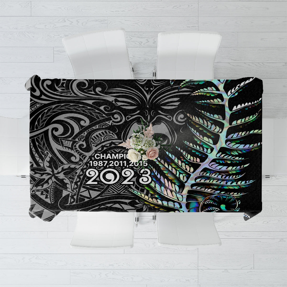 Black tablecloth with teal, green, and blue tribal pattern and champions text