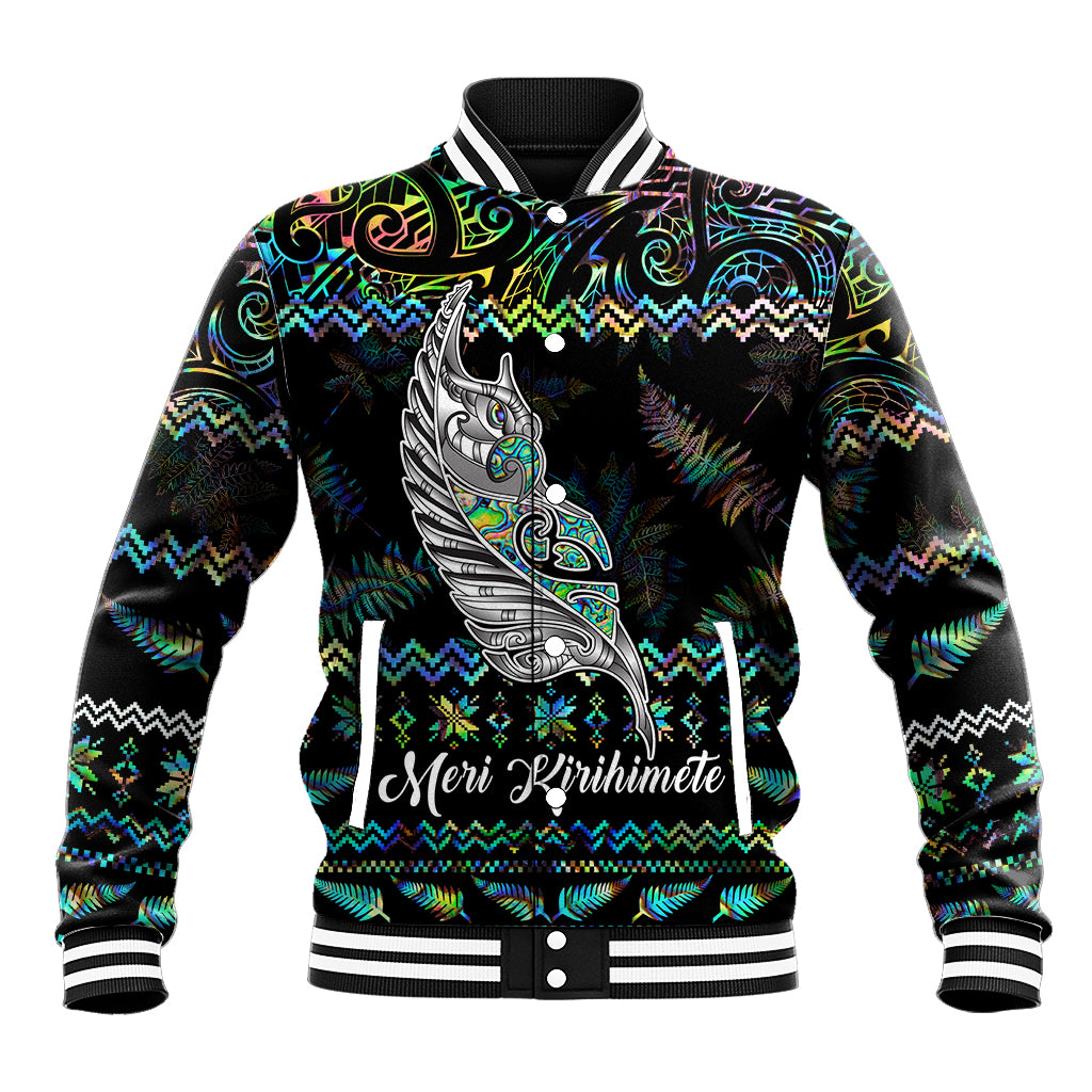 Black baseball jacket with colorful Maori-style patterns and 'Meri Kirihimete' print
