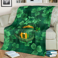 Green 'Feeling Lucky' throw blanket with shamrocks and leprechaun hat graphic