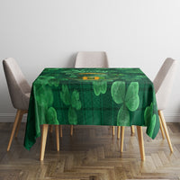 Green plaid tablecloth with large clover shamrock print on tabletop